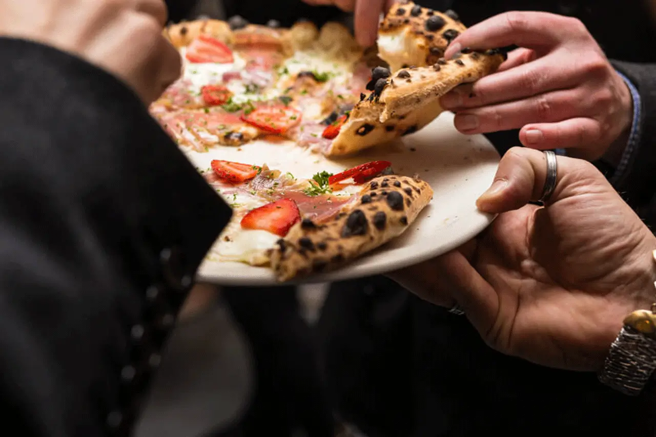 A group of people enjoying pizza
