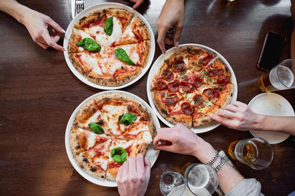 A Margherita pizza and other pizzas